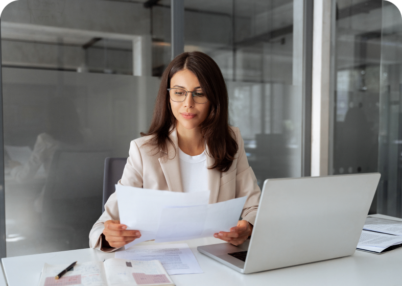 Woman reviewing documents at office desk